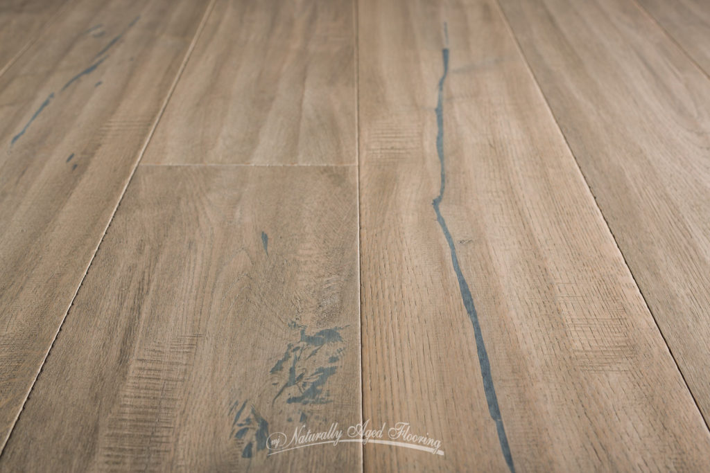 Unique colors and textures help customize spaces, individualizing tastes and styles specific to you. This Naturally Aged Hardwood has high contrast veining with light hand scraped texture.