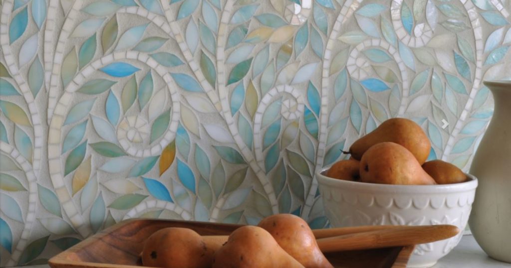 Glass tile mosaic art backsplash in kitchen.