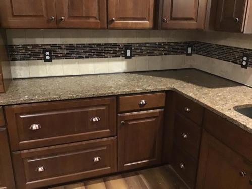 Schluter Dilex AHKA finishing metal cove installed at countertop base for easy cleaning! 